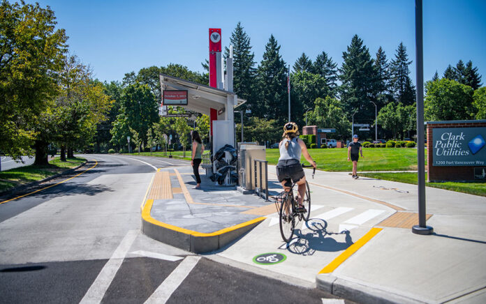 Bicyclist riding around Vancouver bus stops